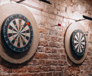 Two dartboards on a vintage brick wall create a retro vibe inside a Belarus café.
