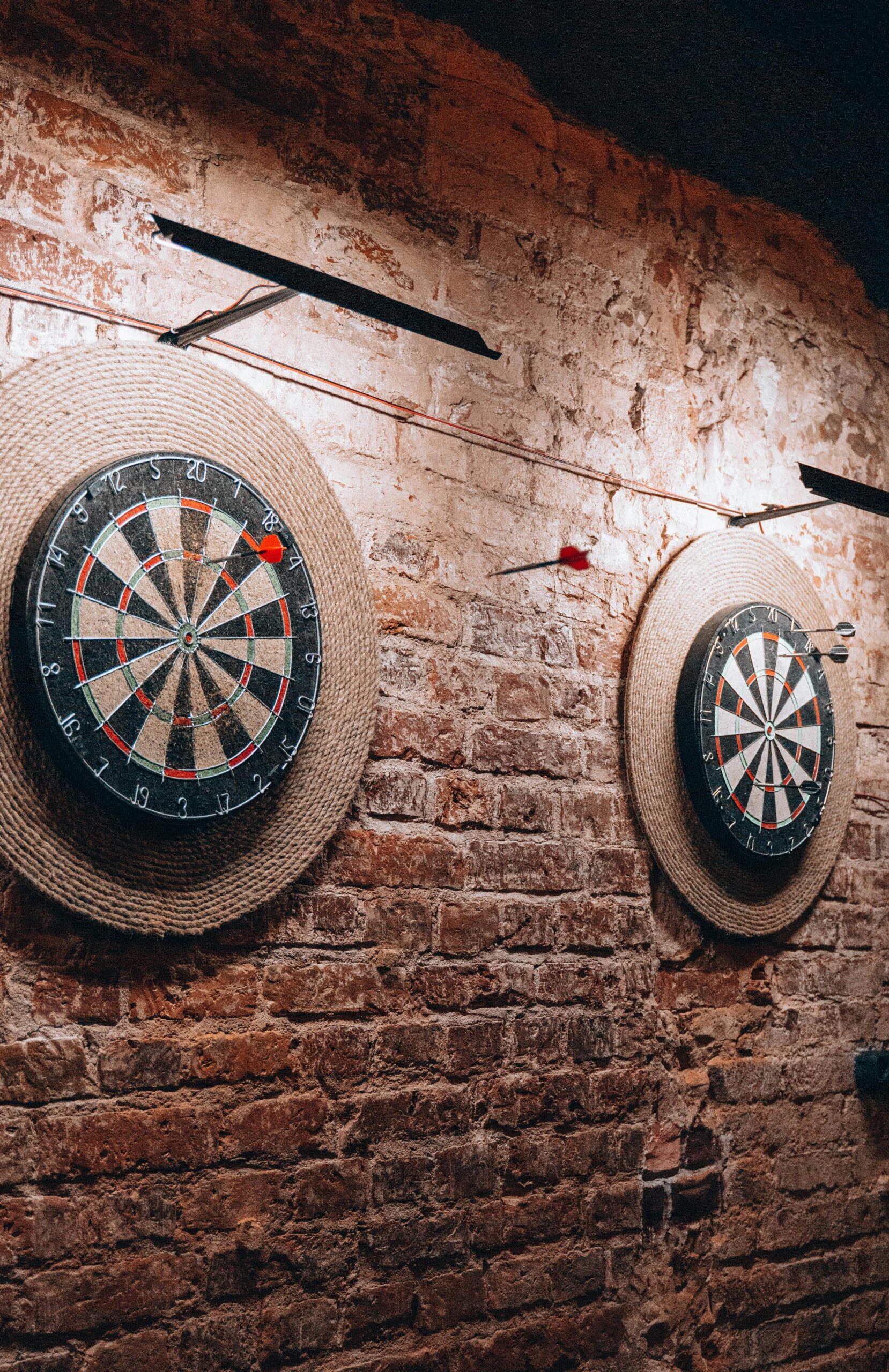 Two dartboards on a vintage brick wall create a retro vibe inside a Belarus café.
