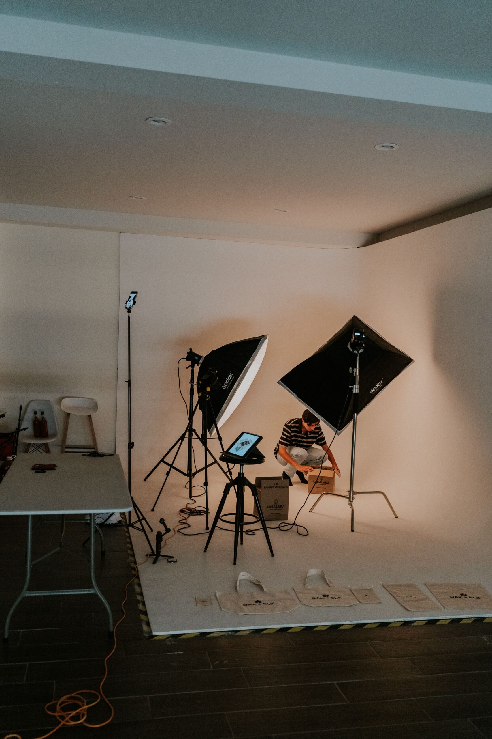 A modern indoor photography studio equipped with lights and camera for a photoshoot session.
